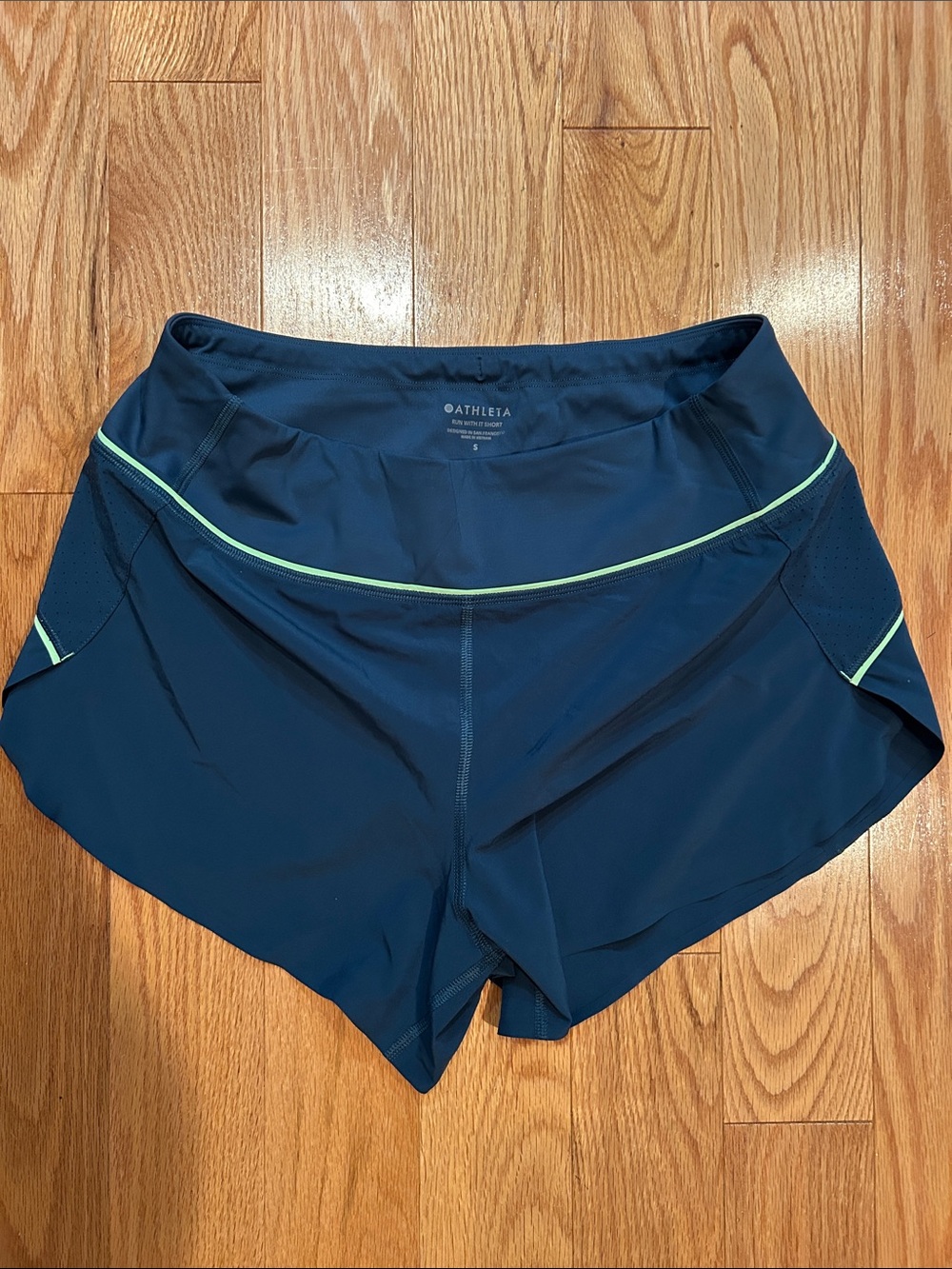 Athleta Run With It Shorts with lime trim and back zip pocket